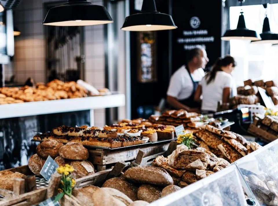 A cafe counter filled with fresh pastries and baking